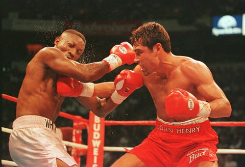 The Fight: De La Hoya gives Whitaker a right jab